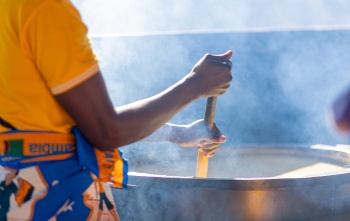 volunteer stirring porridge