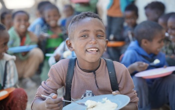 Meareg enjoying his meal
