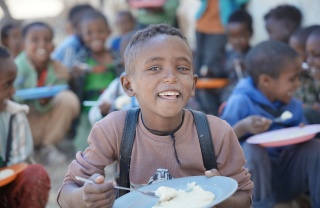 Meareg enjoying his meal