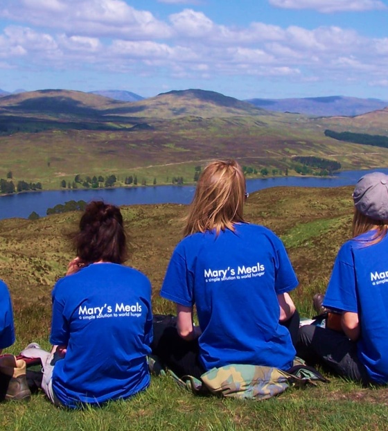A group of volunteers rest while walking the West Highland Way in Scotland
