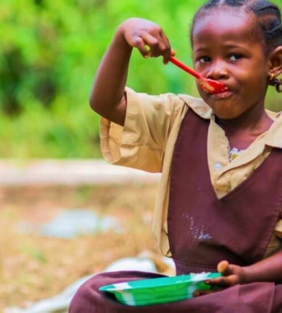 School Child eating a Mary's Meal
