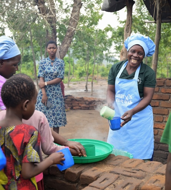 Volunteers serving porridge