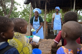 Volunteers serving porridge