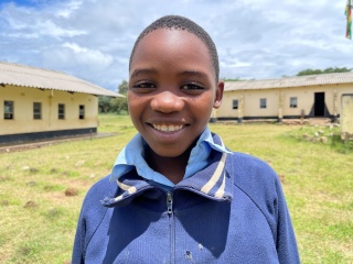 Gugulethu in front of her school