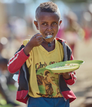 Boys eating porridge